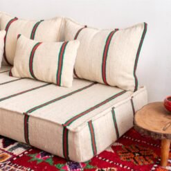 Right view of Moroccan floor sofa in cream with red and green – handmade wool couch for cozy living spaces
