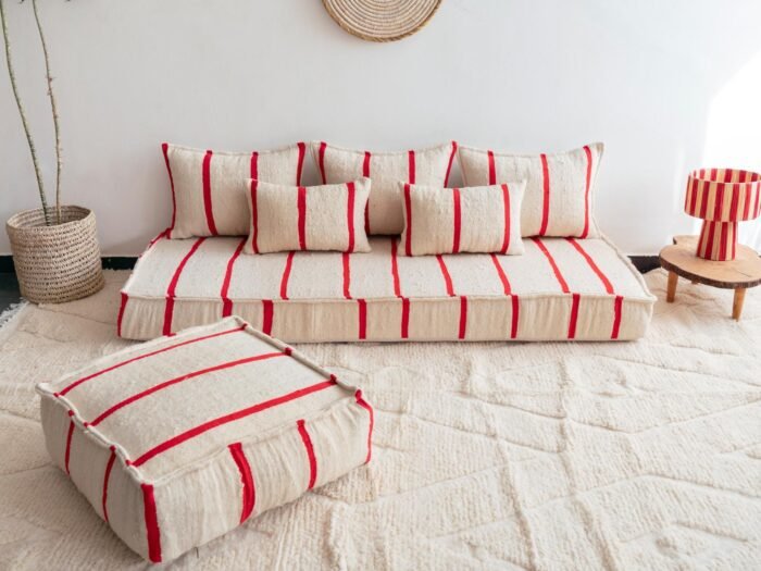 Main image of Moroccan wool floor sofa in cream with red stripes – handcrafted low seating with cushion covers for cozy boho interiors in the USA, UK, and Australia