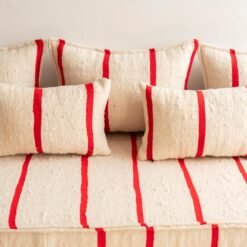 Detailed image of cushions from Moroccan sofa in cream with thin red lines – artisan pillow covers for modern bohemian interiors