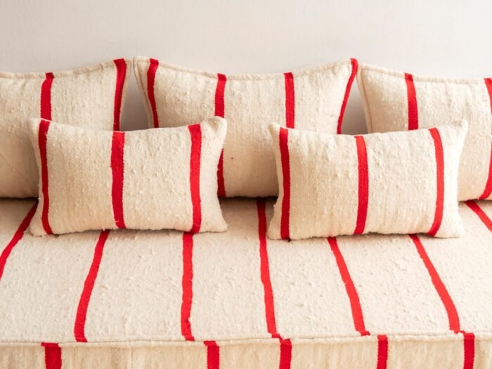 Detailed image of cushions from Moroccan sofa in cream with thin red lines – artisan pillow covers for modern bohemian interiors