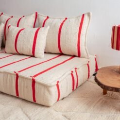 Right side view of Moroccan wool couch in cream with thin red lines – artisan low floor seating for modern and boho-style rooms