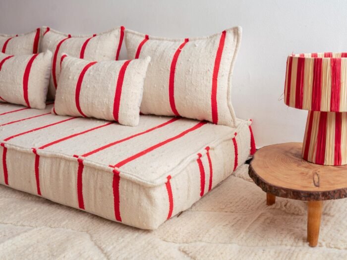 Right side view of Moroccan wool couch in cream with thin red lines – artisan low floor seating for modern and boho-style rooms