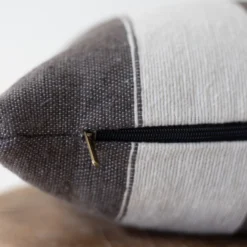 Close-up of off white horizontal stripe texture on dark grey handwoven Moroccan cotton pillow – detailed artisan weaving