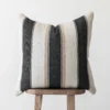 Moroccan throw pillow with bold cream, tan, and black stripes – handwoven cotton cushion styled for modern neutral or bohemian home interiors
