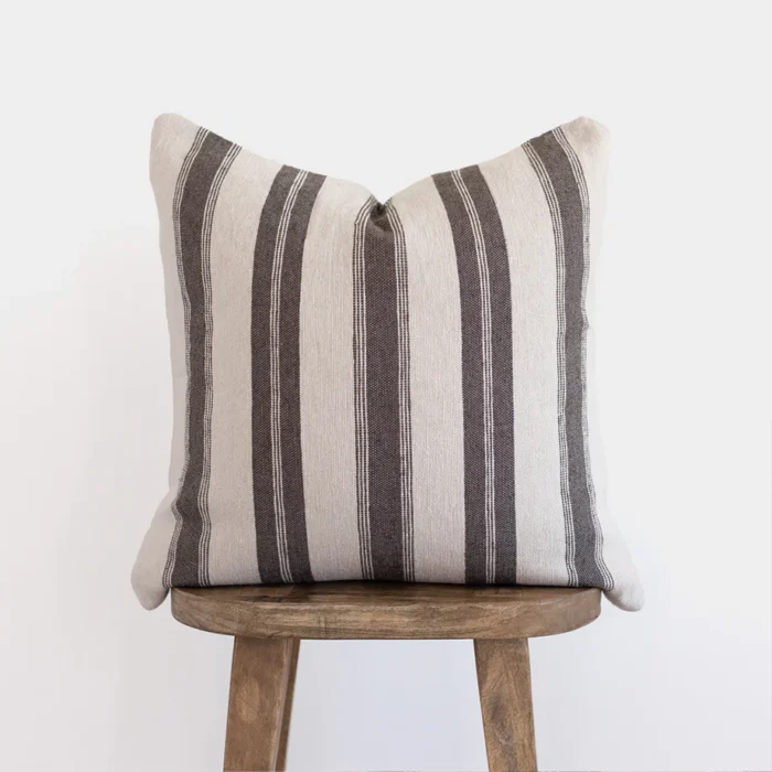 Front view of handwoven Moroccan pillow in white with horizontal warm grey stripes – minimalist and artisan cotton cushion for neutral interiors