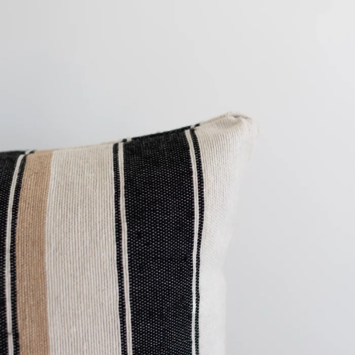 Striped Moroccan pillow – features cream, tan, and black bands in handwoven cotton, perfect for rustic and minimalist spaces