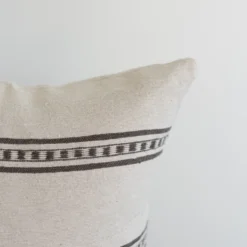 Three-quarter angle of white Moroccan pillow cover with woven brown stripes – handcrafted cotton cushion perfect for minimalist and boho décor