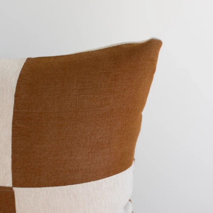 Close-up of handwoven Moroccan pillow with spice and cream checker design – artisan cotton weave for cozy home styling