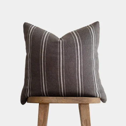 warm charcoal Moroccan pillow with horizontal cream stripes – handmade cotton cushion for neutral and bohemian interiors