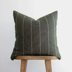 Front view of moss green Moroccan pillow with horizontal off-white stripes – handcrafted cotton cushion for earthy and boho interior decor