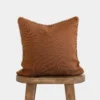 Front view of Moroccan pillow in spice color with cream stitching around the edges – handmade cotton cushion for boho and earthy interiors