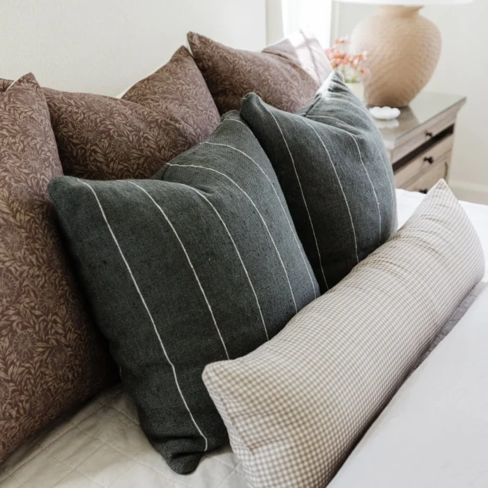 handwoven moss green pillow featuring delicate off-white horizontal stripes – bohemian artisan cushion for sofa or bed styling