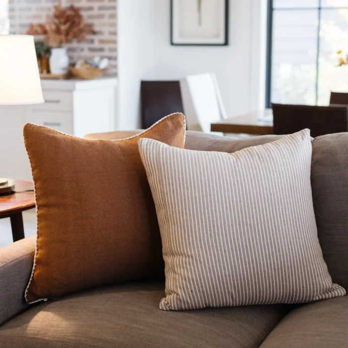 cream-stitched border on a handwoven Moroccan spice pillow – detailed craftsmanship in cotton artisan home decor