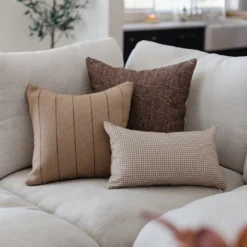 Tan Moroccan pillows with subtle spice stripes styled in a boho interior – artisan cotton cushion decor in 18", 20", 24"
