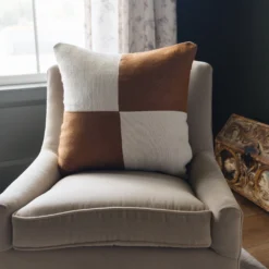 Cream and spice checker Moroccan pillow styled in a modern boho interior – handmade cotton cushion on a cozy sofa setting