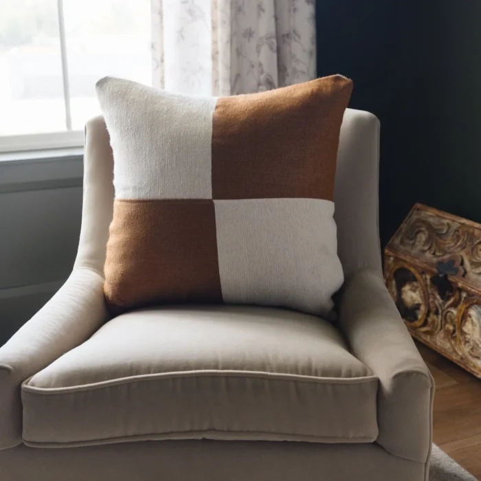 Cream and spice checker Moroccan pillow styled in a modern boho interior – handmade cotton cushion on a cozy sofa setting