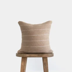 Handwoven tan Moroccan pillow with horizontal white stripe pattern – handmade cotton cushion available in 18", 20", and 24"