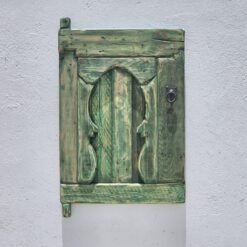 traditional Amazigh carvings on weathered cedar wood wall panel