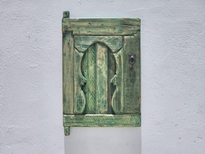 traditional Amazigh carvings on weathered cedar wood wall panel