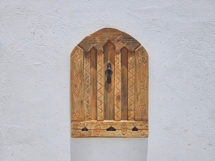 Berber carvings on reclaimed cedar wood panel with vintage finish
