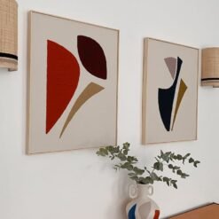 Framed abstract wool wall art hanging on a neutral-colored wall, adding warmth and texture to a modern living room.