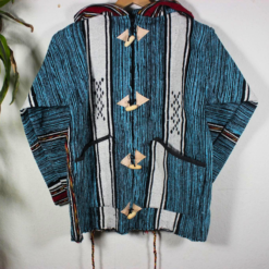 Turquoise and black patterned Moroccan fleece hoodie, unisex boho jacket with artisan wooden toggles, premium fleece blend, ideal for layering and casual wear in USA, UK, Europe