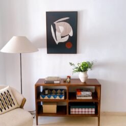 Framed abstract wool artwork hanging on a wall in a modern interior setting, showcasing minimalist organic design.