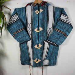 Turquoise and black patterned handmade Moroccan fleece hoodie, unisex Berber-inspired boho jacket with cozy hood and traditional wooden toggle buttons, crafted from premium natural wool and fleece – warm artisan outerwear perfect for festivals, travel, casual wear, and layering, popular in USA, UK, and European bohemian fashion markets.