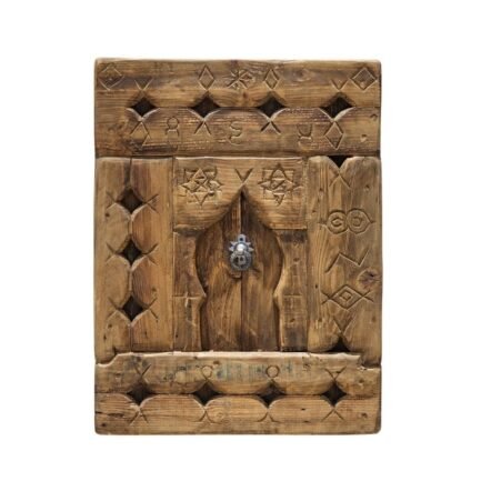 Handcrafted vintage Moroccan wall panel featuring tribal Berber carvings and rustic aged wood
