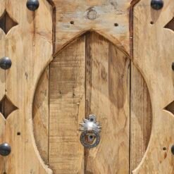 Center view of Moroccan panel featuring symmetrical carving and vintage knocker