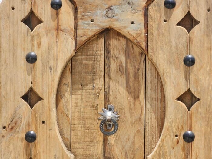 Center view of Moroccan panel featuring symmetrical carving and vintage knocker