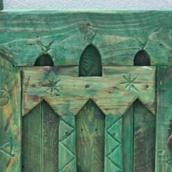 Vintage Moroccan handcrafted window panel styled as rustic wall decor in interior space