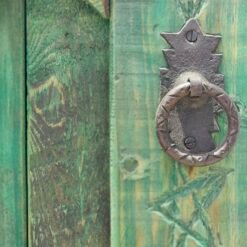 carved details and iron studwork on the vintage Moroccan wooden window