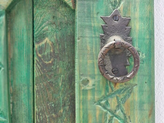 carved details and iron studwork on the vintage Moroccan wooden window