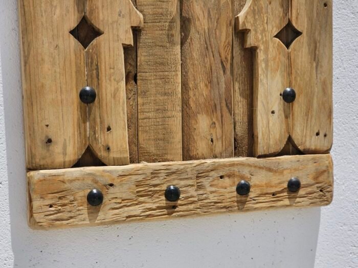 Close-up of bottom detail of Moroccan wooden panel showing natural wood grain and studs