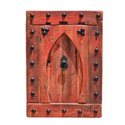 Vintage Moroccan wall panel with Moorish arch design in red rustic wood, mounted on white wall