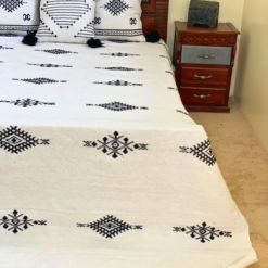 traditional Moroccan handwoven white blanket with black embroidery – artisan wool throw with embroidered cushions
