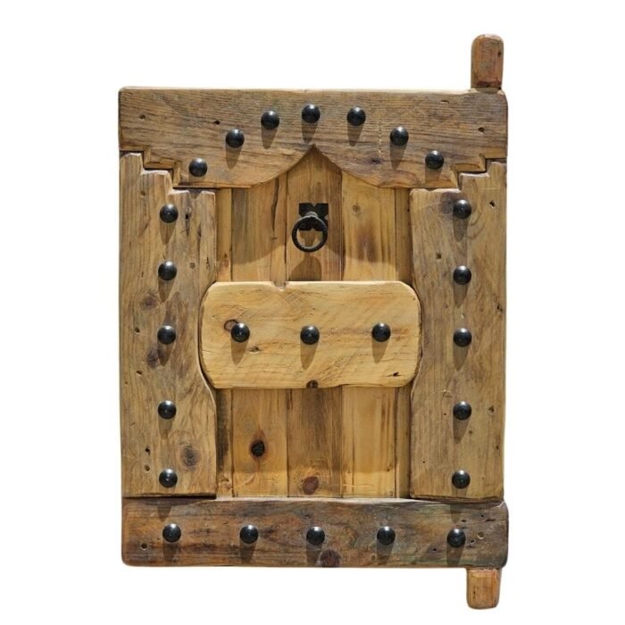 vintage wooden Moroccan shutter with black iron studs