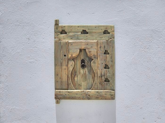 Berber carvings on aged cedar wood panel