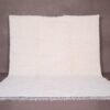 Authentic handmade Moroccan white Beni Ourain rug crafted from 100% natural wool by skilled Berber women artisans. This minimalist solid white wool carpet features a soft texture and timeless elegance, perfect for modern, Scandinavian, or bohemian home interiors. Ideal for living rooms, bedrooms, or wall decor.