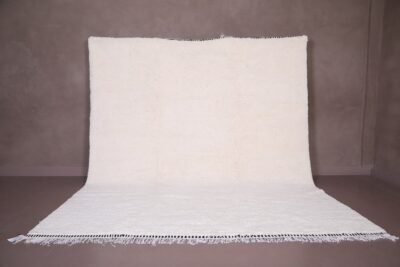 Authentic handmade Moroccan white Beni Ourain rug crafted from 100% natural wool by skilled Berber women artisans. This minimalist solid white wool carpet features a soft texture and timeless elegance, perfect for modern, Scandinavian, or bohemian home interiors. Ideal for living rooms, bedrooms, or wall decor.