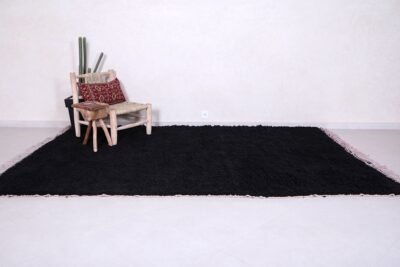 traditional black Moroccan Beni Ourain rug, highlighting the precision of Berber craftsmanship and the smooth finish of high-quality natural wool. A luxurious accent for bedrooms, lofts, or cozy reading nooks