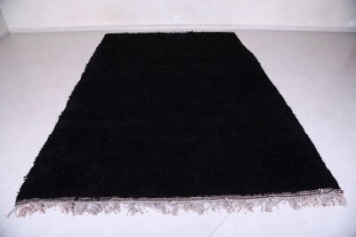 hand-knotted Moroccan black Beni Ourain rug showing the plush wool texture and thick pile. Woven in the Atlas Mountains, this rug adds depth and softness to any room while standing out as a timeless statement piece