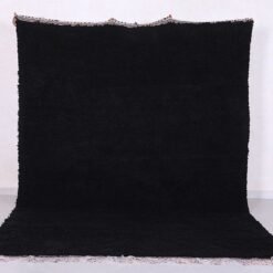 Authentic handmade Moroccan black Beni Ourain rug crafted from 100% natural wool by skilled Berber women artisans. This luxurious black wool rug brings bold elegance, warmth, and cultural charm to modern, bohemian, or minimalist interiors. Perfect for living rooms, bedrooms, or as an eye-catching wall tapestry.
