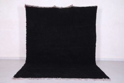 Authentic handmade Moroccan black Beni Ourain rug crafted from 100% natural wool by skilled Berber women artisans. This luxurious black wool rug brings bold elegance, warmth, and cultural charm to modern, bohemian, or minimalist interiors. Perfect for living rooms, bedrooms, or as an eye-catching wall tapestry.