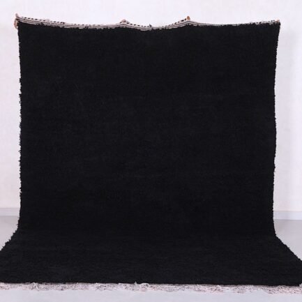 Authentic handmade Moroccan black Beni Ourain rug crafted from 100% natural wool by skilled Berber women artisans. This luxurious black wool rug brings bold elegance, warmth, and cultural charm to modern, bohemian, or minimalist interiors. Perfect for living rooms, bedrooms, or as an eye-catching wall tapestry.