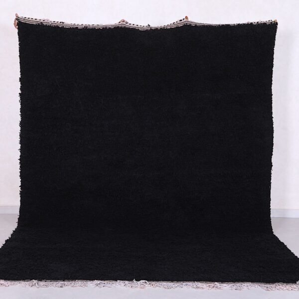 Authentic handmade Moroccan black Beni Ourain rug crafted from 100% natural wool by skilled Berber women artisans. This luxurious black wool rug brings bold elegance, warmth, and cultural charm to modern, bohemian, or minimalist interiors. Perfect for living rooms, bedrooms, or as an eye-catching wall tapestry.