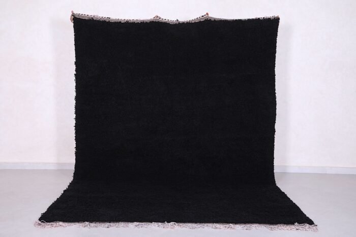 Authentic handmade Moroccan black Beni Ourain rug crafted from 100% natural wool by skilled Berber women artisans. This luxurious black wool rug brings bold elegance, warmth, and cultural charm to modern, bohemian, or minimalist interiors. Perfect for living rooms, bedrooms, or as an eye-catching wall tapestry.