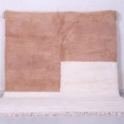 Contemporary handmade Moroccan Beni Ourain rug in ivory and tan, crafted with 100% natural lamb wool and traditional Berber weaving.