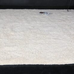 This unique Ivory Moroccan rug with Plain field is an essential element for any home, be it a fancy urban studio, a ranch log house, or a cozy family home in a small town